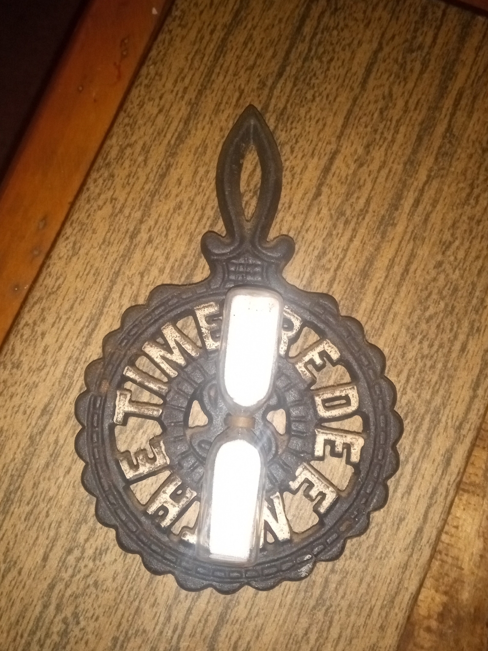 Vintage cast iron trivet "THE TIME REDEEMED".